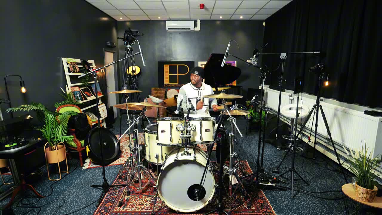 O’TEGA performing behind a full drum kit at Ediasproduction